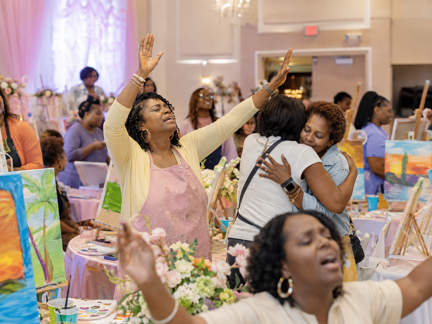 Women worshipping with hands raised